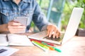 Business womenÃ¢â¬â¢s sitting in office and working her computer laptop on desk with using smartphone. Woman analyzing data Royalty Free Stock Photo